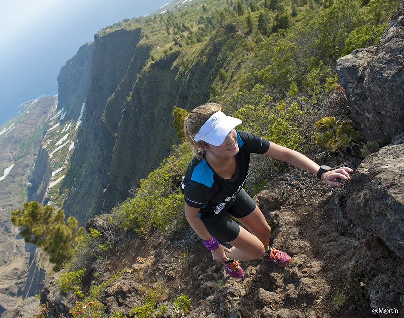 A photo of a runner climbing on a trail during Transvulcania 2016