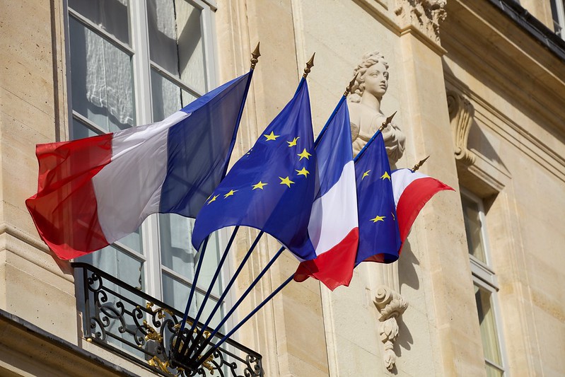 Paris, France. French and European flags floating in the wind on the Élysée palace entrance gates